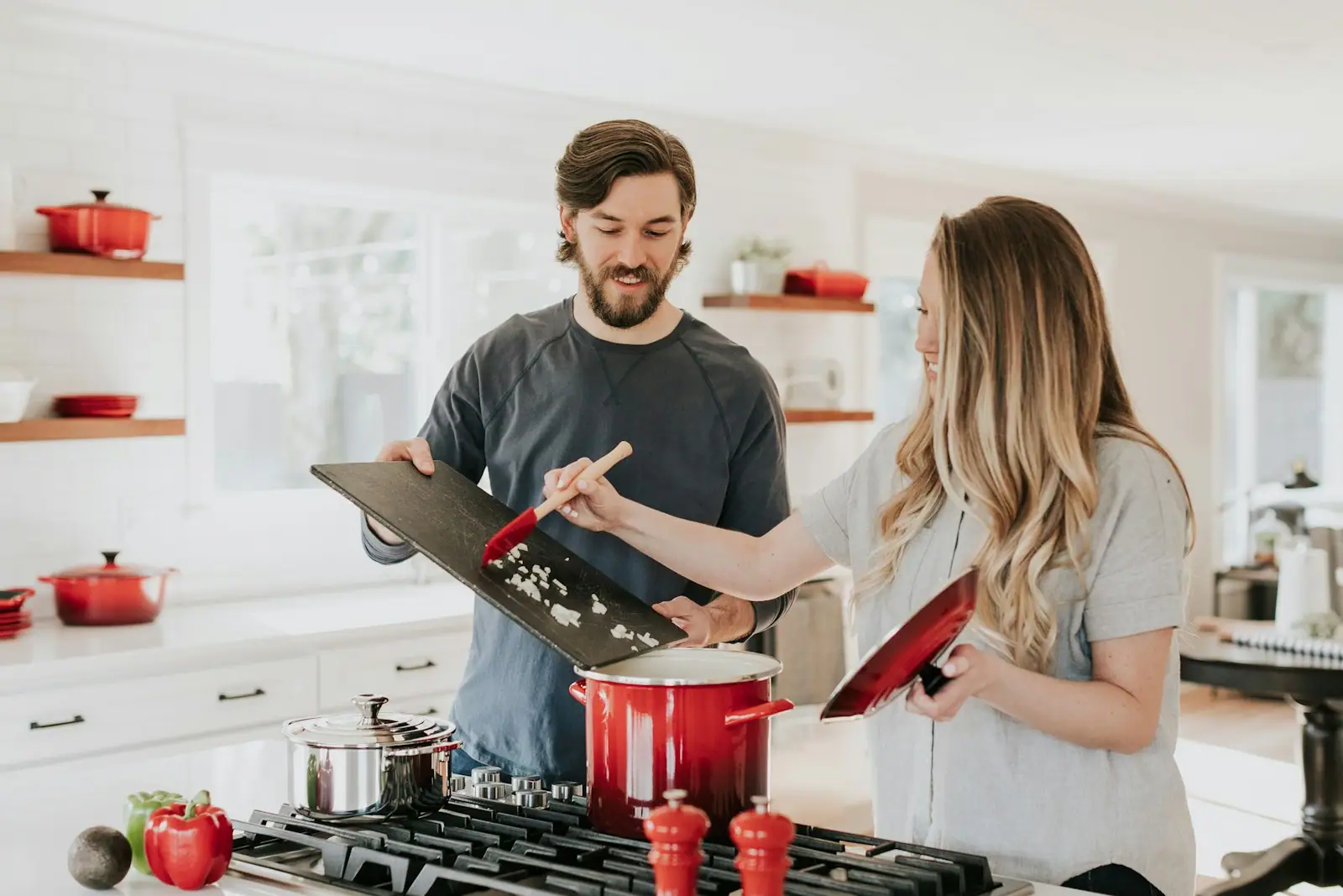 Couple cooking in a white kitchen