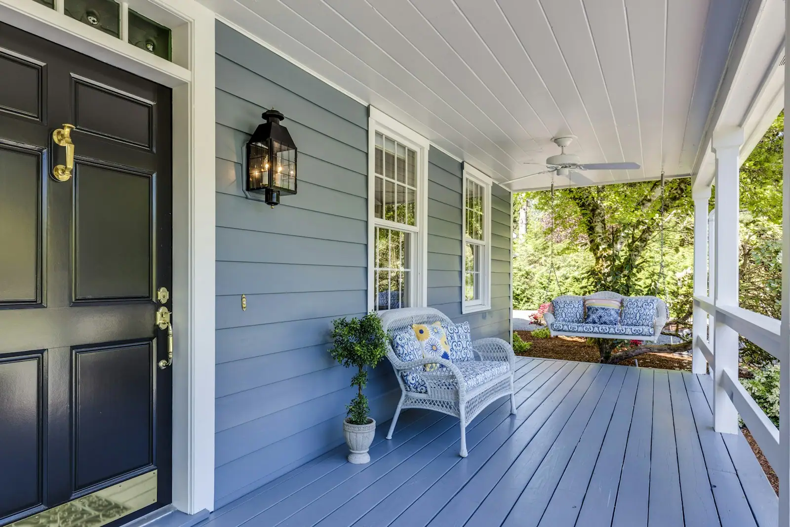 Covered front porch with a painted wood ceiling