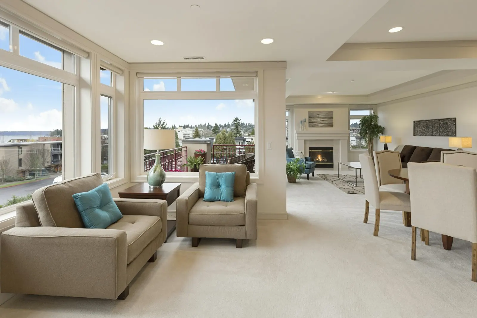 Sunlit open living and dining room with a wall of windows