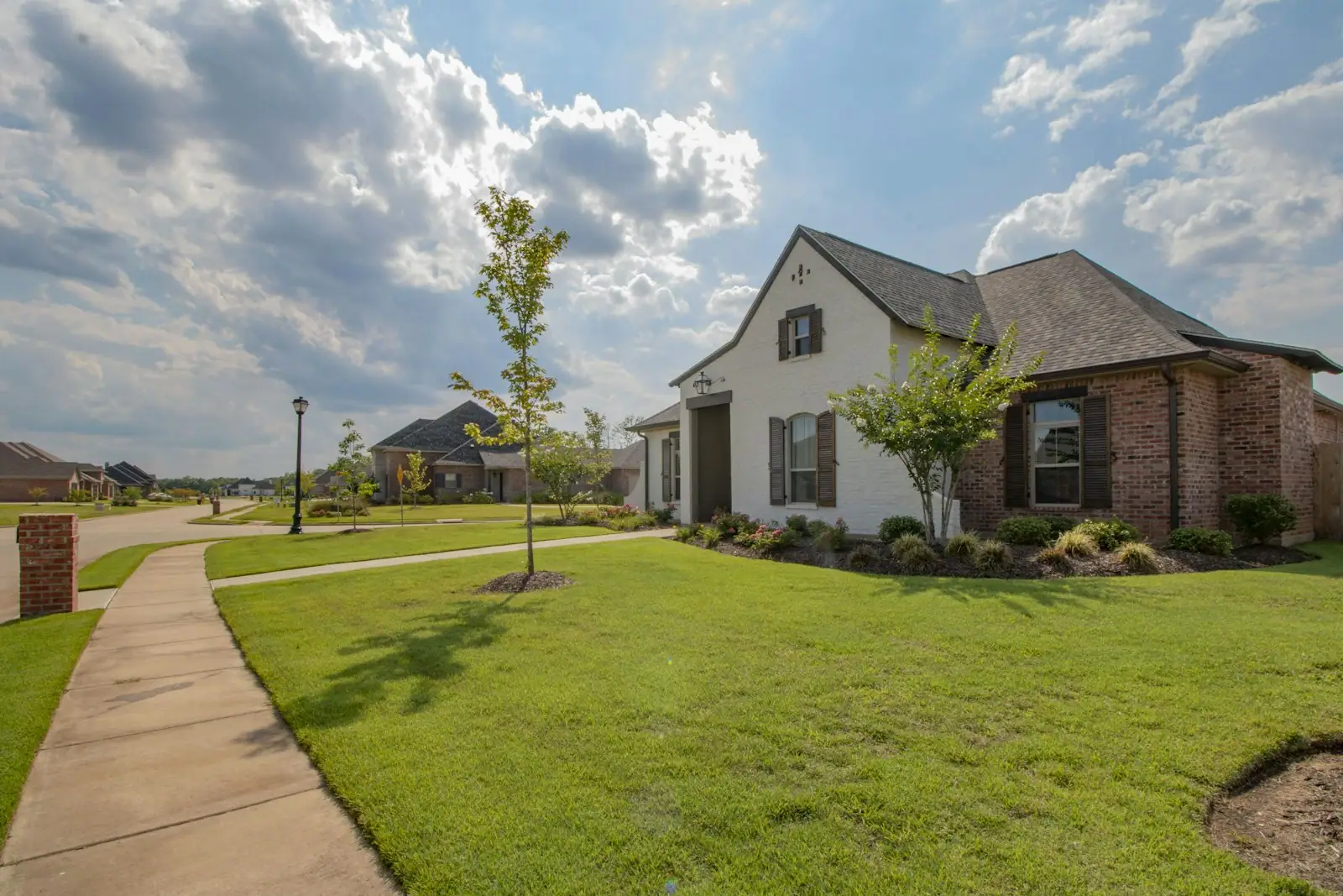 Brick and stone home with a curved front walk