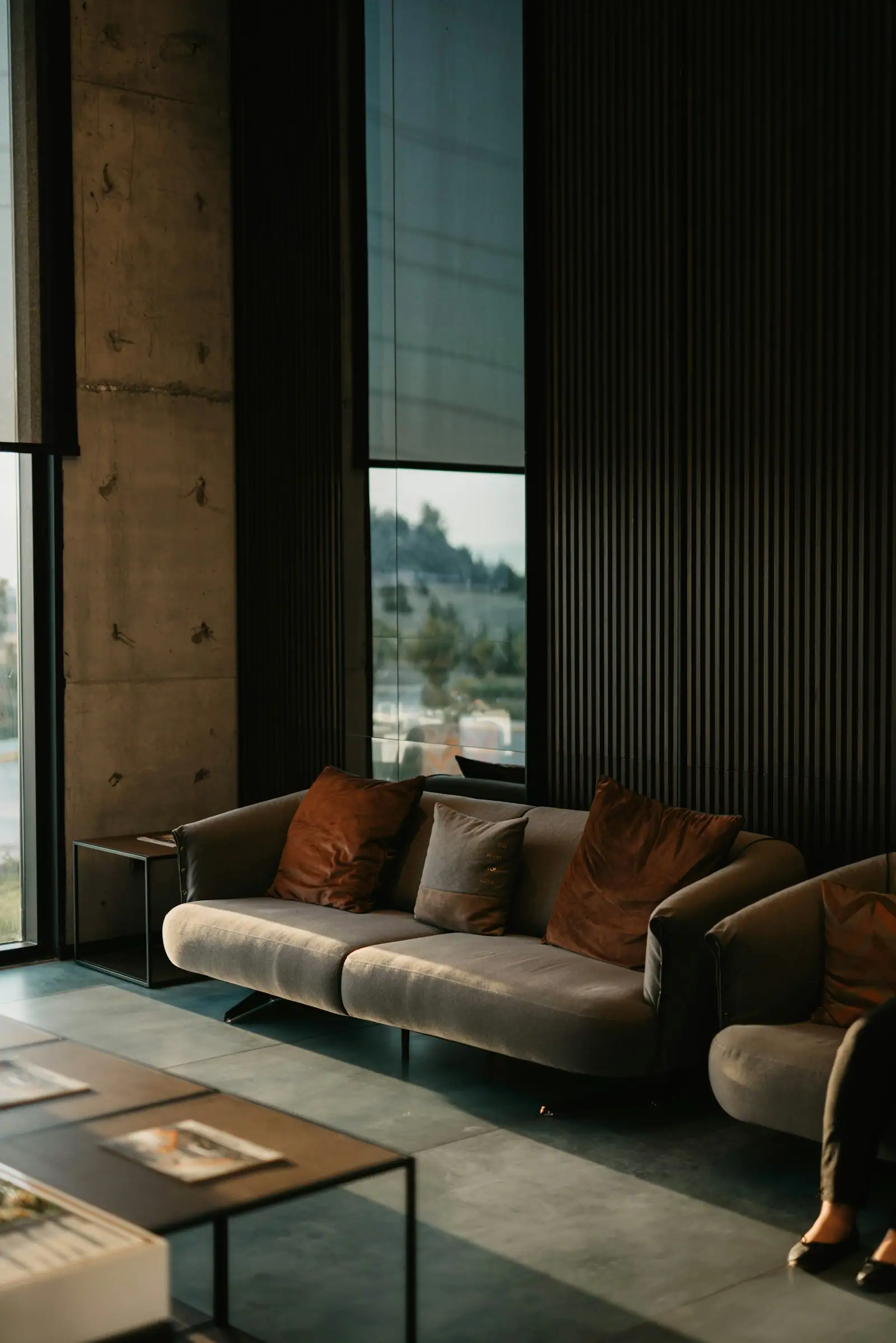 Moody lounge with dark walls and a leather sofa