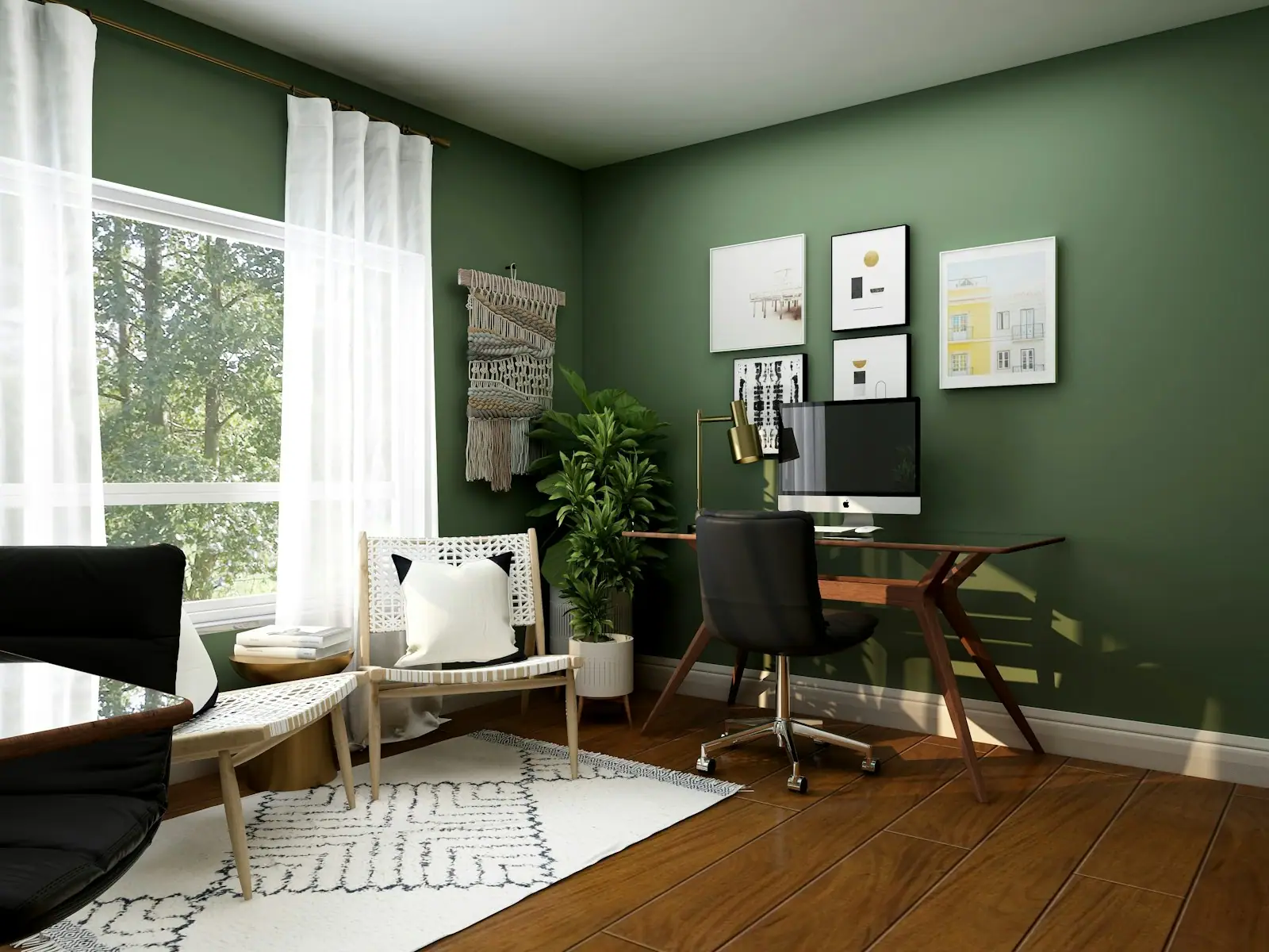 Home office with green walls and a wood desk