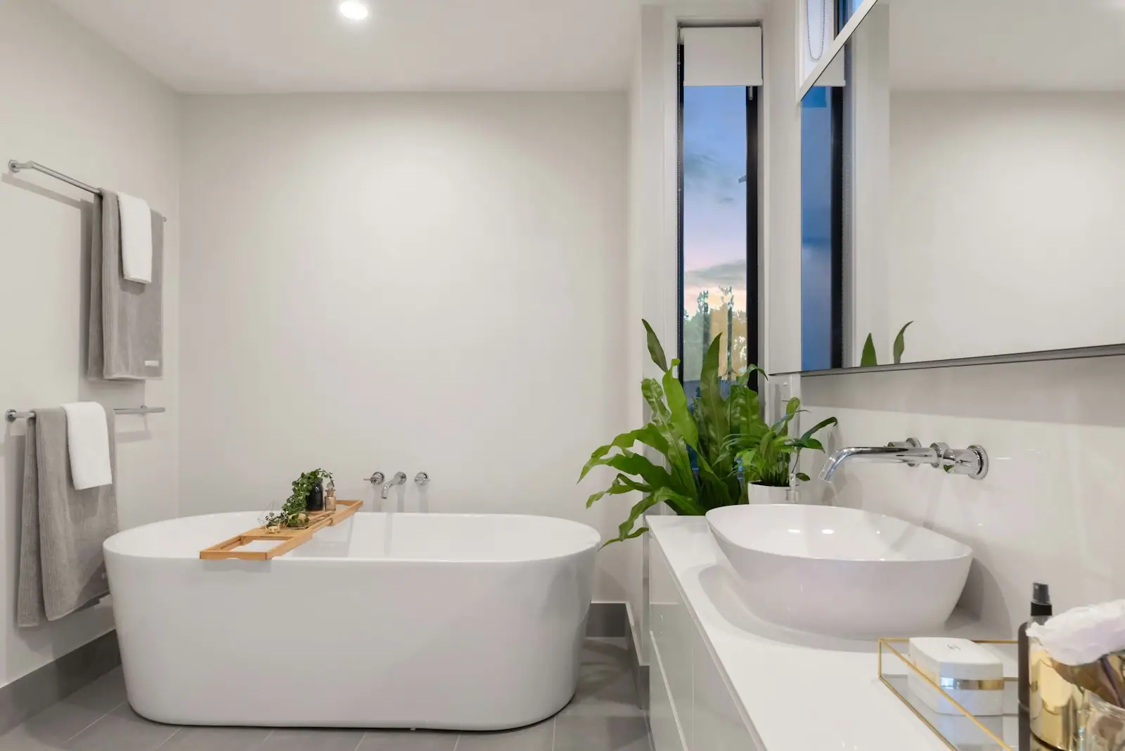 Freestanding tub and vessel sink in a bright bathroom